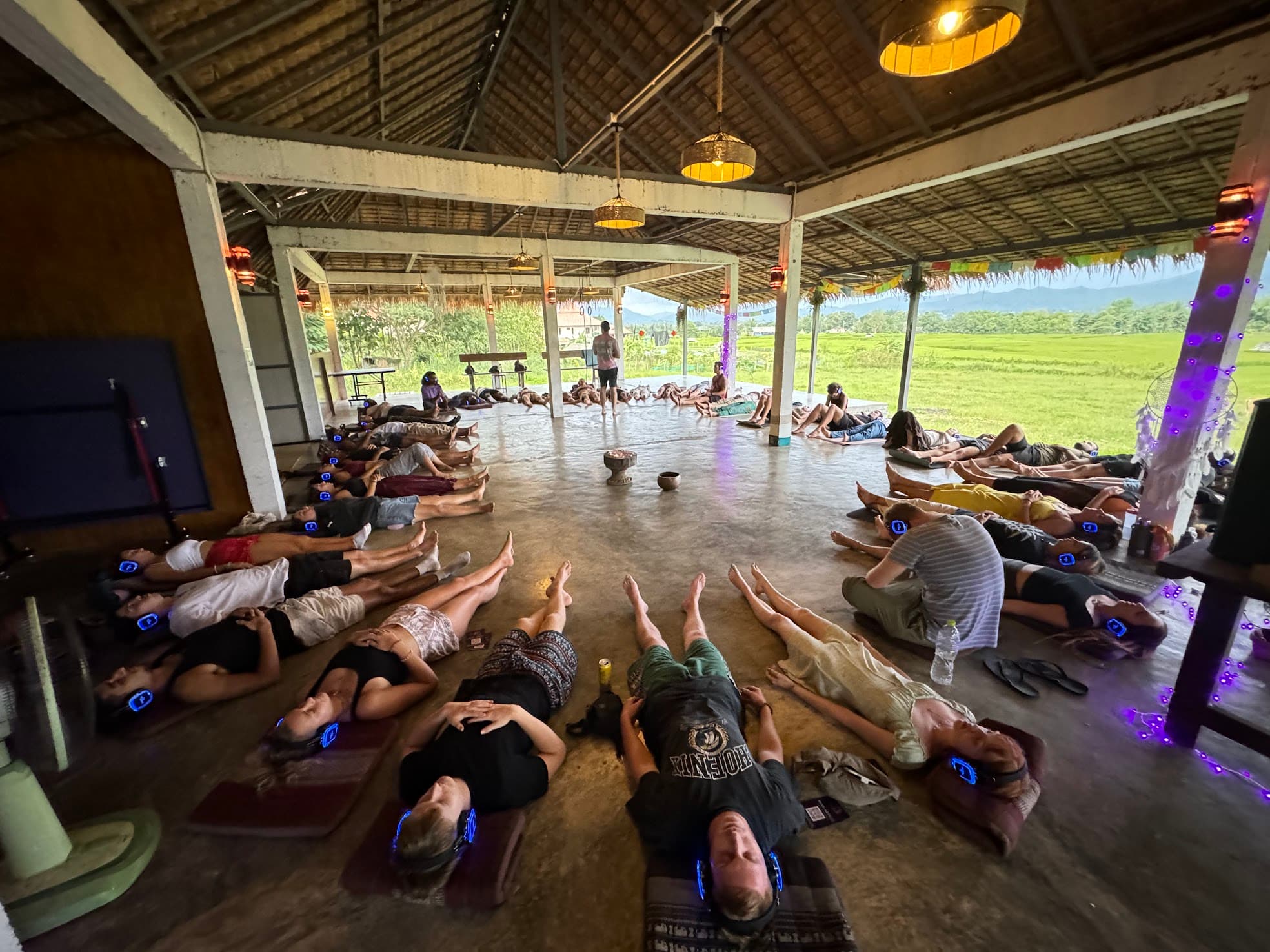 Participants lying on the floor in a circle during a guided Mind Artists hypnosis practice.